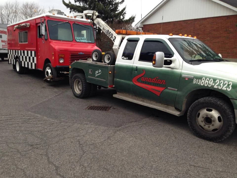 Canadian Towing providing RV towing in Ontario with a professional tow truck safely transporting a motorhome near Ottawa