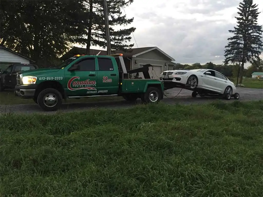 Canadian Towing removing an abandoned vehicle from a commercial property in Ottawa with professional towing equipment